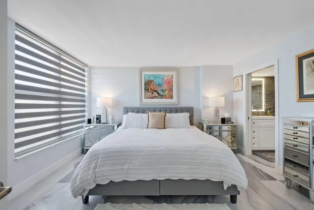 a bedroom with furniture and a flat screen tv