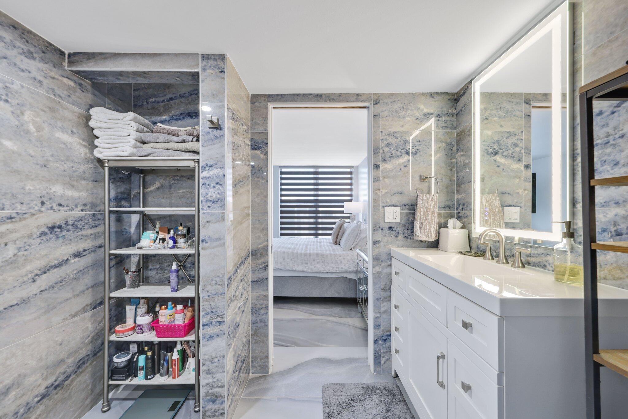 12 Royal Palm Way, Unit 605 Boca Raton, FL 33432 - Photo 27 of 47 a en suite bathroom with a sink and a large mirror