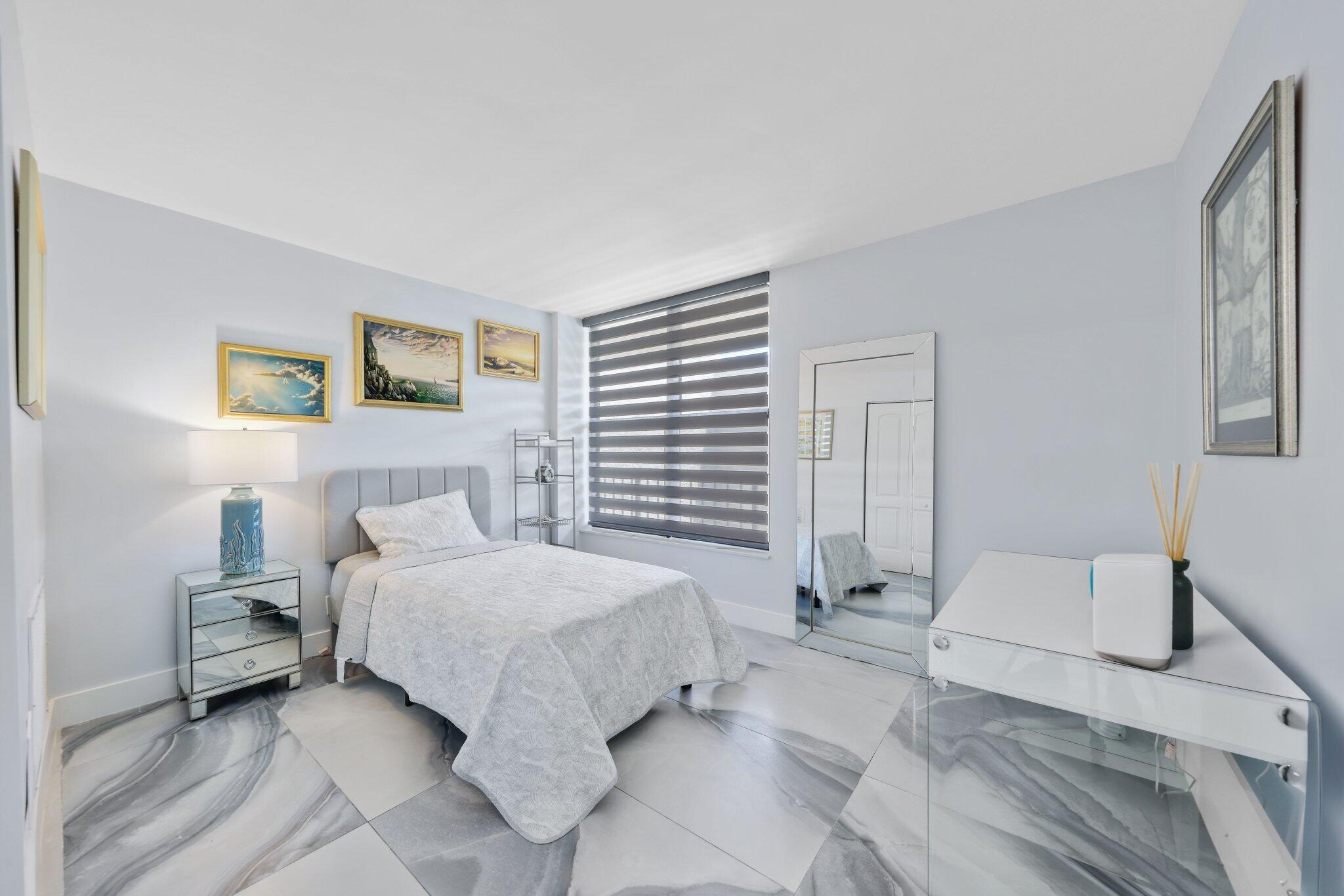 12 Royal Palm Way, Unit 605 Boca Raton, FL 33432 - Photo 28 of 47 a bedroom with a bed and a couch