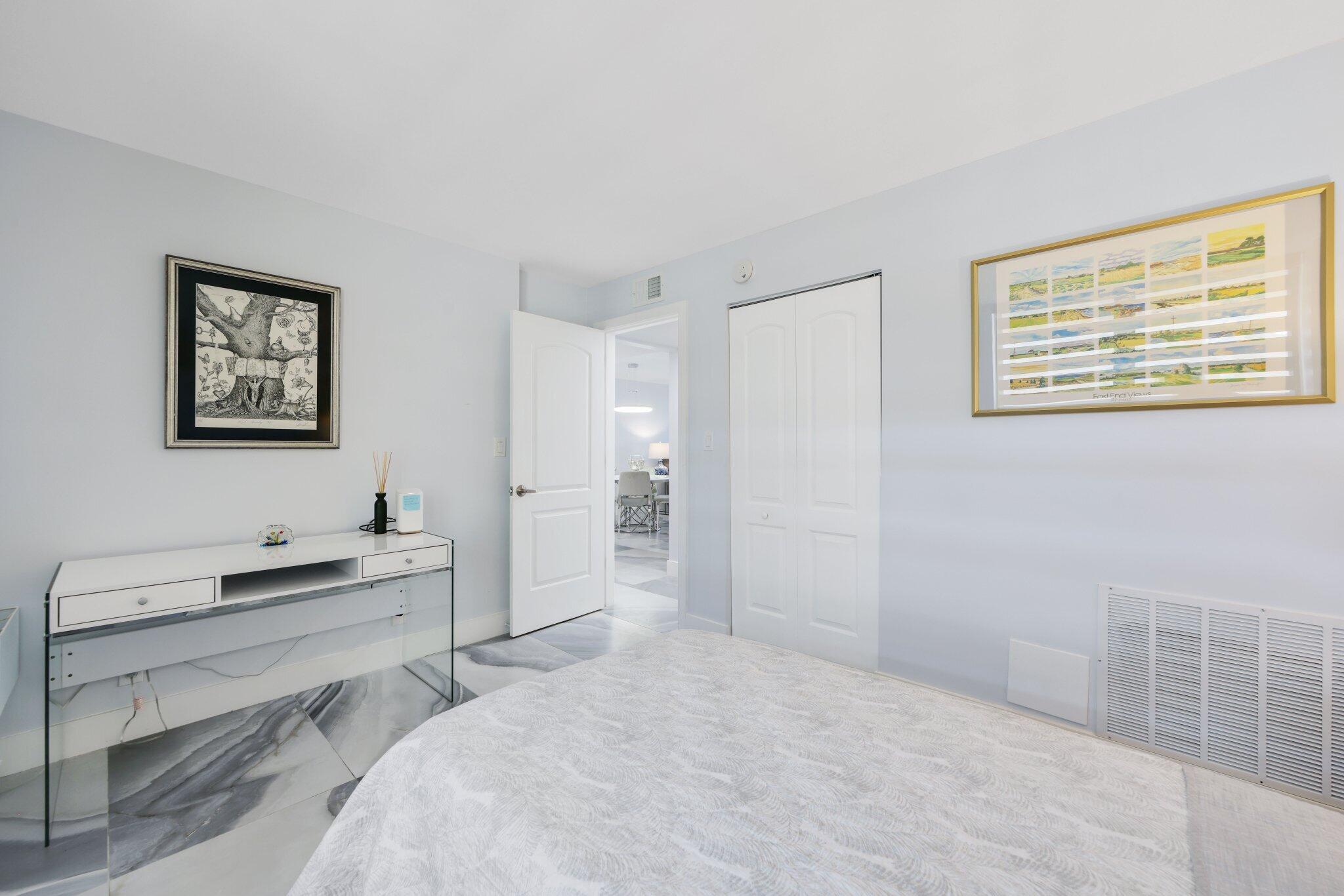 12 Royal Palm Way, Unit 605 Boca Raton, FL 33432 - Photo 29 of 47 a bedroom with a bed and a desk