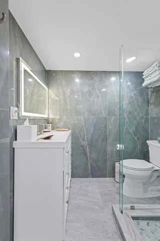 a bathroom with a sink toilet and shower