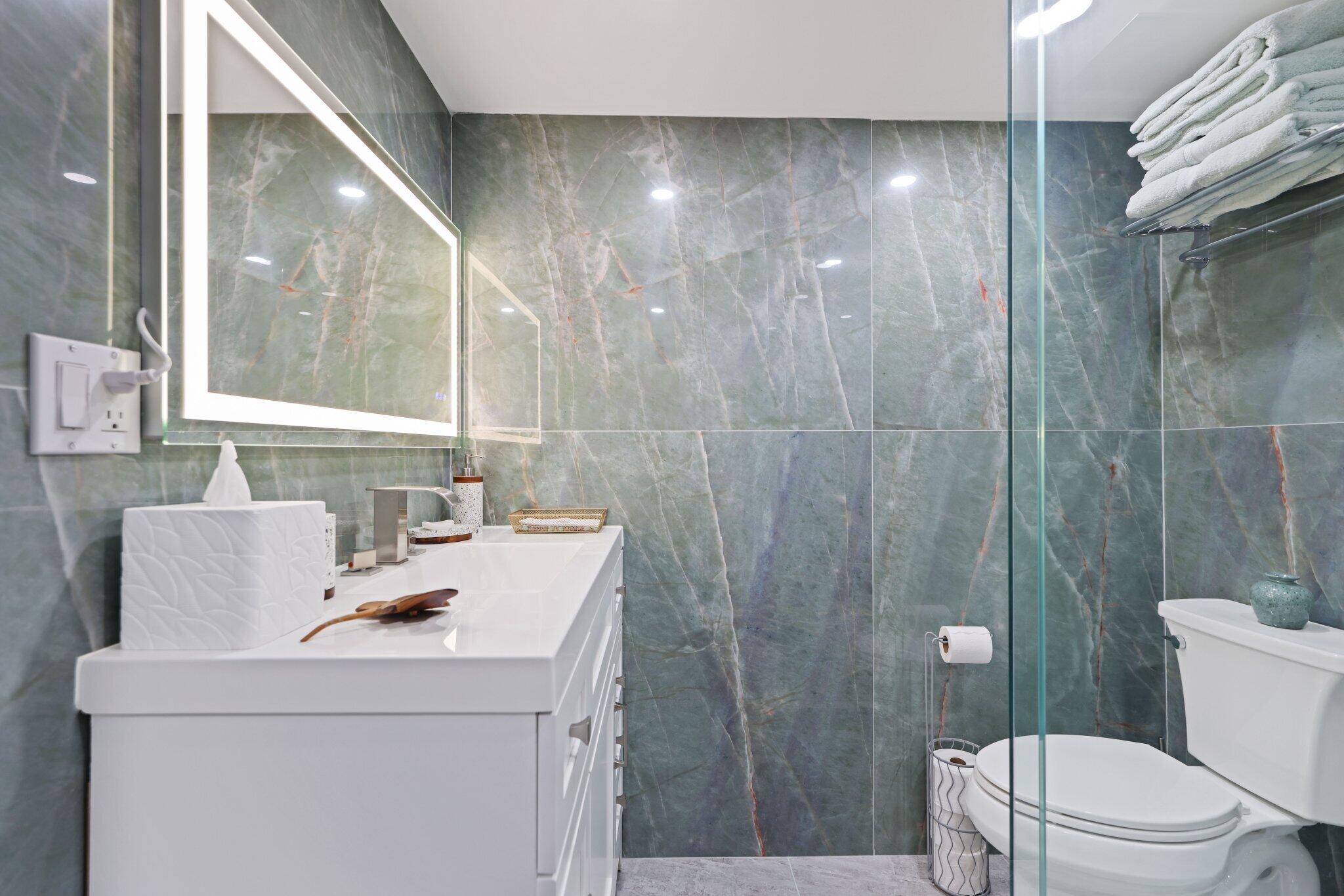 12 Royal Palm Way, Unit 605 Boca Raton, FL 33432 - Photo 32 of 47 a bathroom with a sink toilet and shower