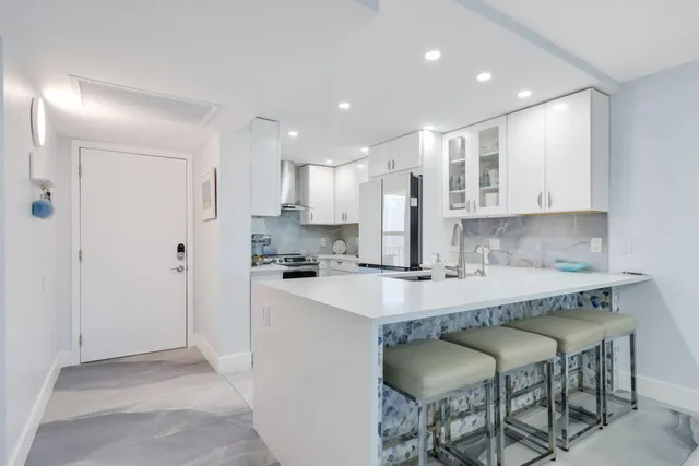 a kitchen with a table chairs stove and kitchen view