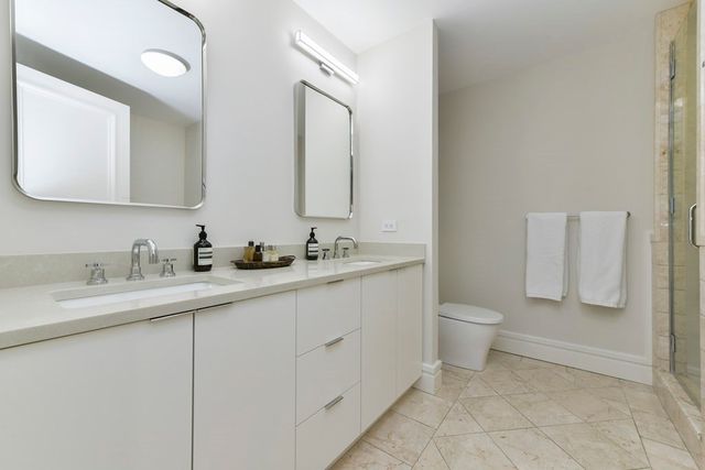 a bathroom with a toilet sink and mirror