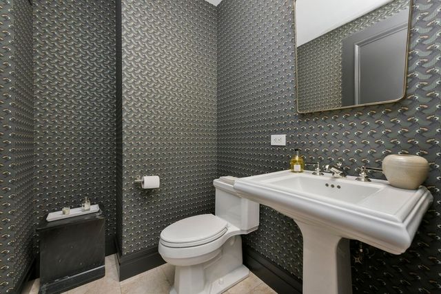 a bathroom with a sink a toilet and mirror