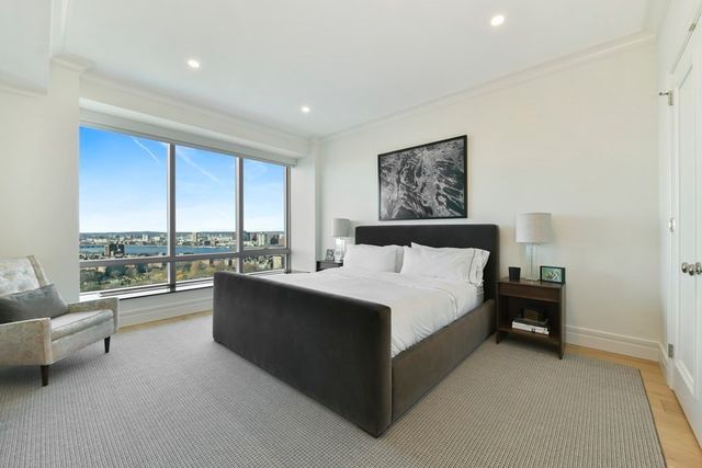 a large bedroom with a bed and large window