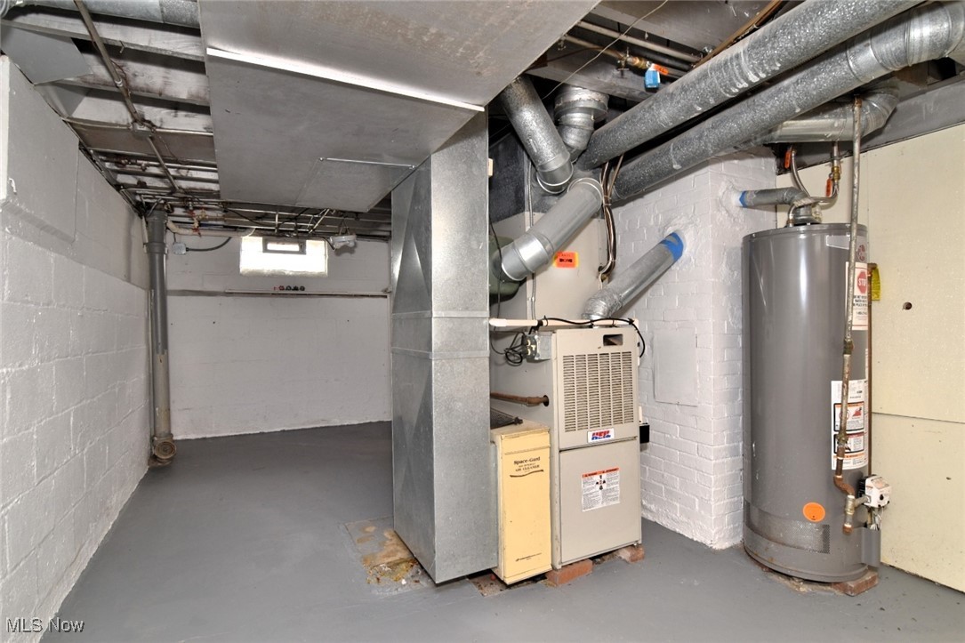 1443 Churchill Road Lyndhurst, OH 44124 - Photo 24 of 39 Utility room featuring water heater and heating unit