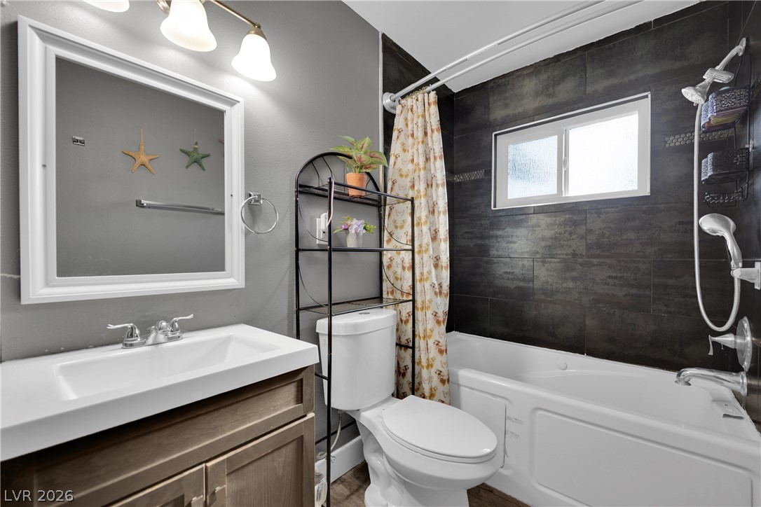 2221 Englestad Street North Las Vegas, NV 89030 - Photo 18 of 32 A refreshing bathroom with clean lines and modern dark tilework around the tub.