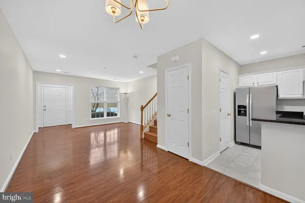 a view of empty room with wooden floor and window