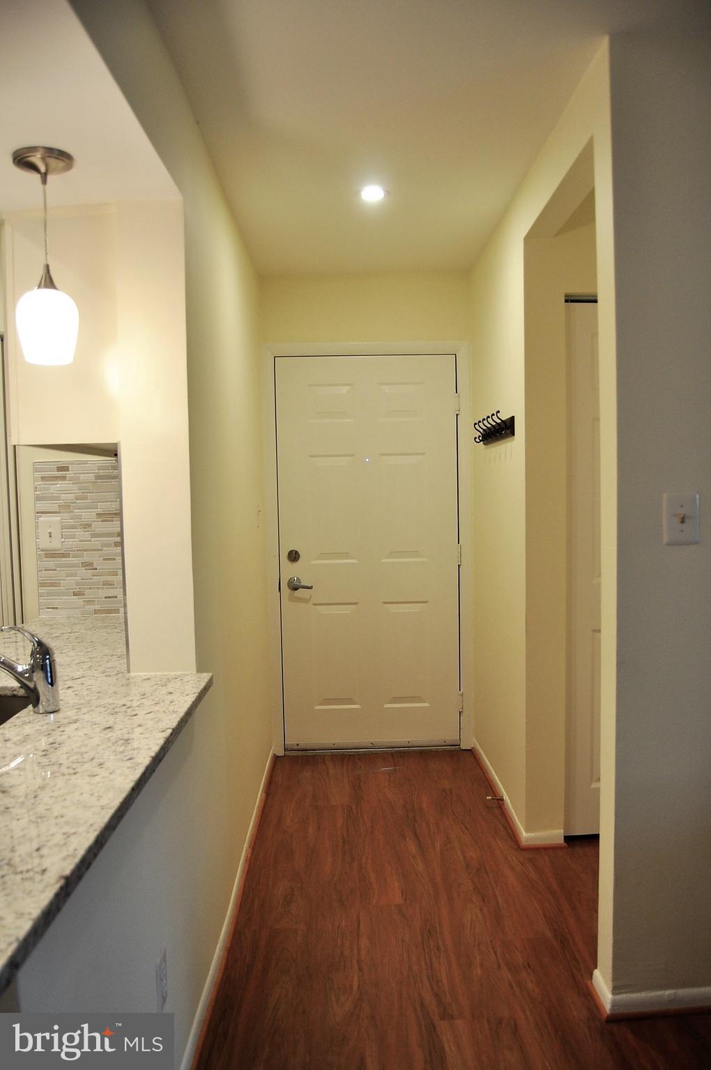 1706 Ascot Way, Unit A Reston, VA 20190 - Photo 3 of 30 Private entry with coat closet and coat rack.