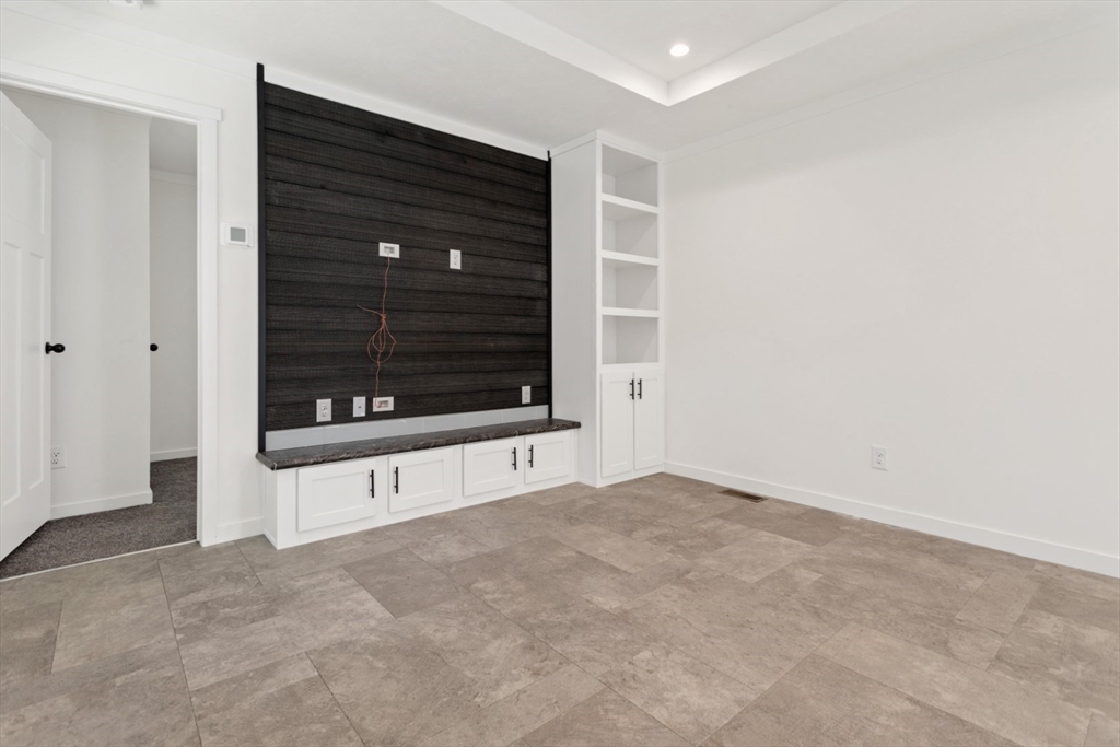 98 Newbury Street, Unit 4B Danvers, MA 01923 - Photo 11 of 32 a view of an empty room with a fireplace