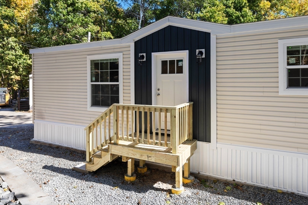 98 Newbury Street, Unit 4B Danvers, MA 01923 - Photo 12 of 32 a view of a wooden bench in front of house