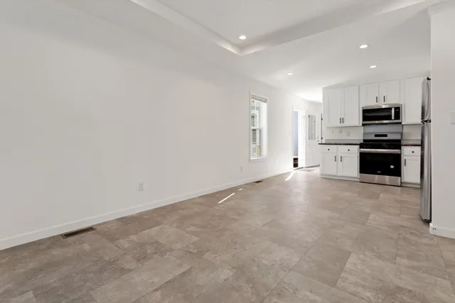 a view of kitchen with a sink stove and refrigerator