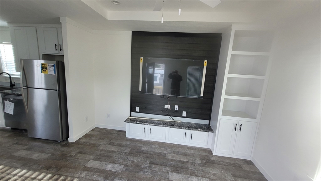 98 Newbury Street, Unit 4B Danvers, MA 01923 - Photo 2 of 32 a view of an empty room and a kitchen