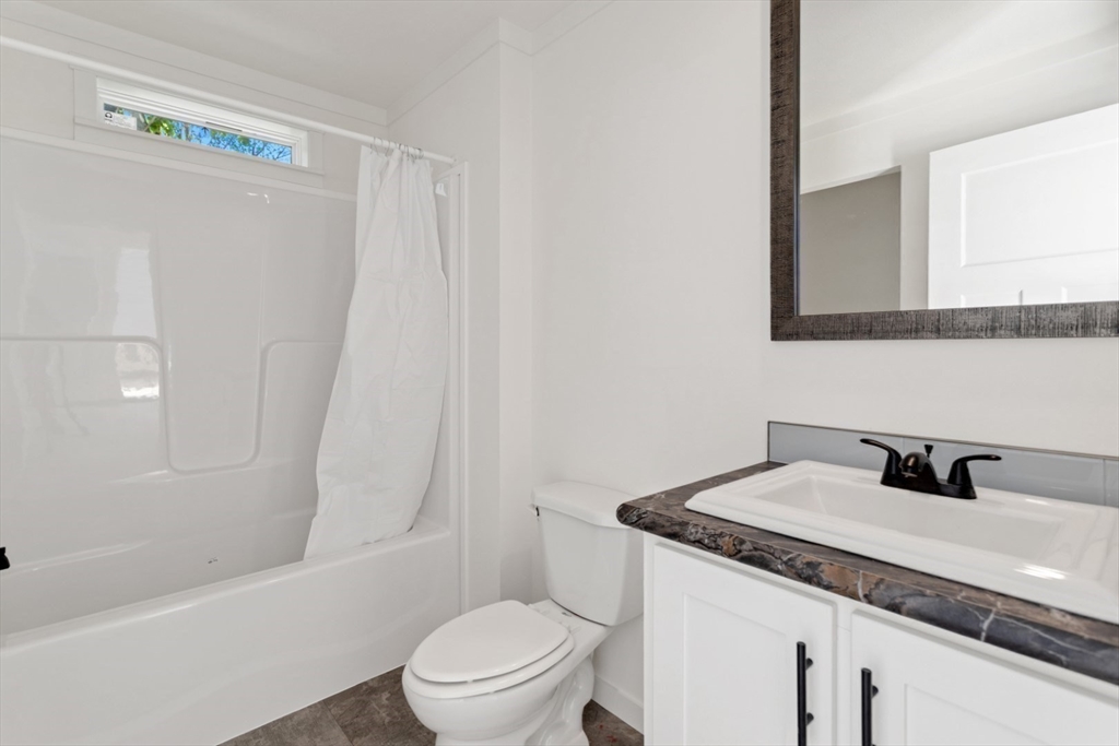 98 Newbury Street, Unit 4B Danvers, MA 01923 - Photo 24 of 32 a bathroom with a granite countertop sink toilet and shower