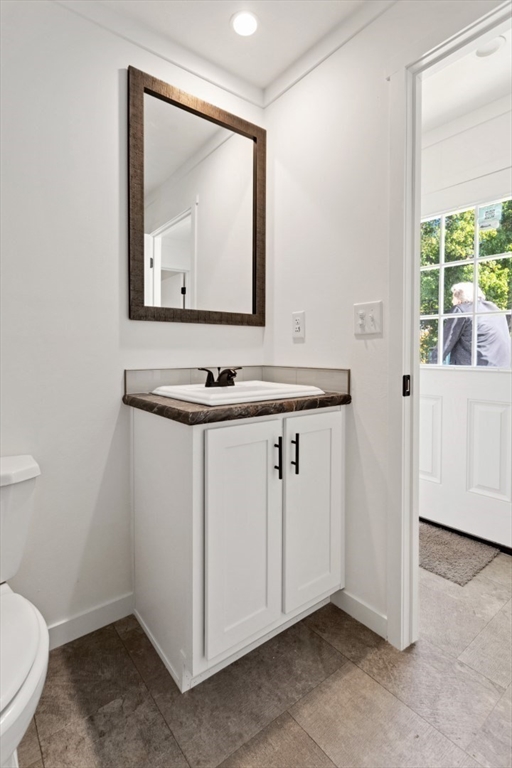 98 Newbury Street, Unit 4B Danvers, MA 01923 - Photo 25 of 32 a bathroom with a toilet sink and mirror