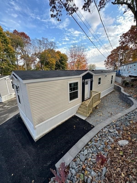 98 Newbury Street, Unit 4B Danvers, MA 01923 - Photo 31 of 32 a view of a back yard of the house