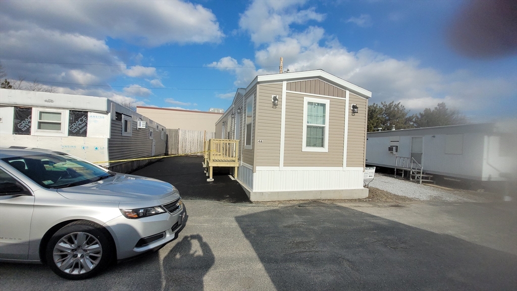 98 Newbury Street, Unit 4B Danvers, MA 01923 - Photo 4 of 32 a car parked in front of house