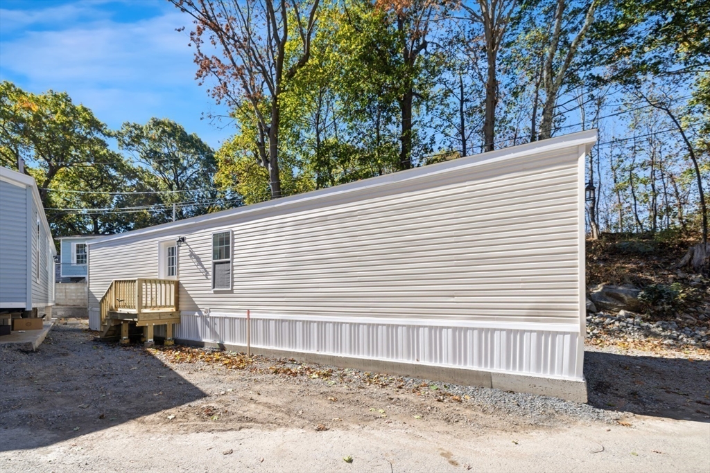98 Newbury Street, Unit 4B Danvers, MA 01923 - Photo 6 of 32 a view of a house with a backyard
