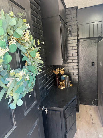 47 B Street Helper, UT 84526 - Photo 16 of 19 Black paneled door with round knob, contrasting with a black-painted brick wall