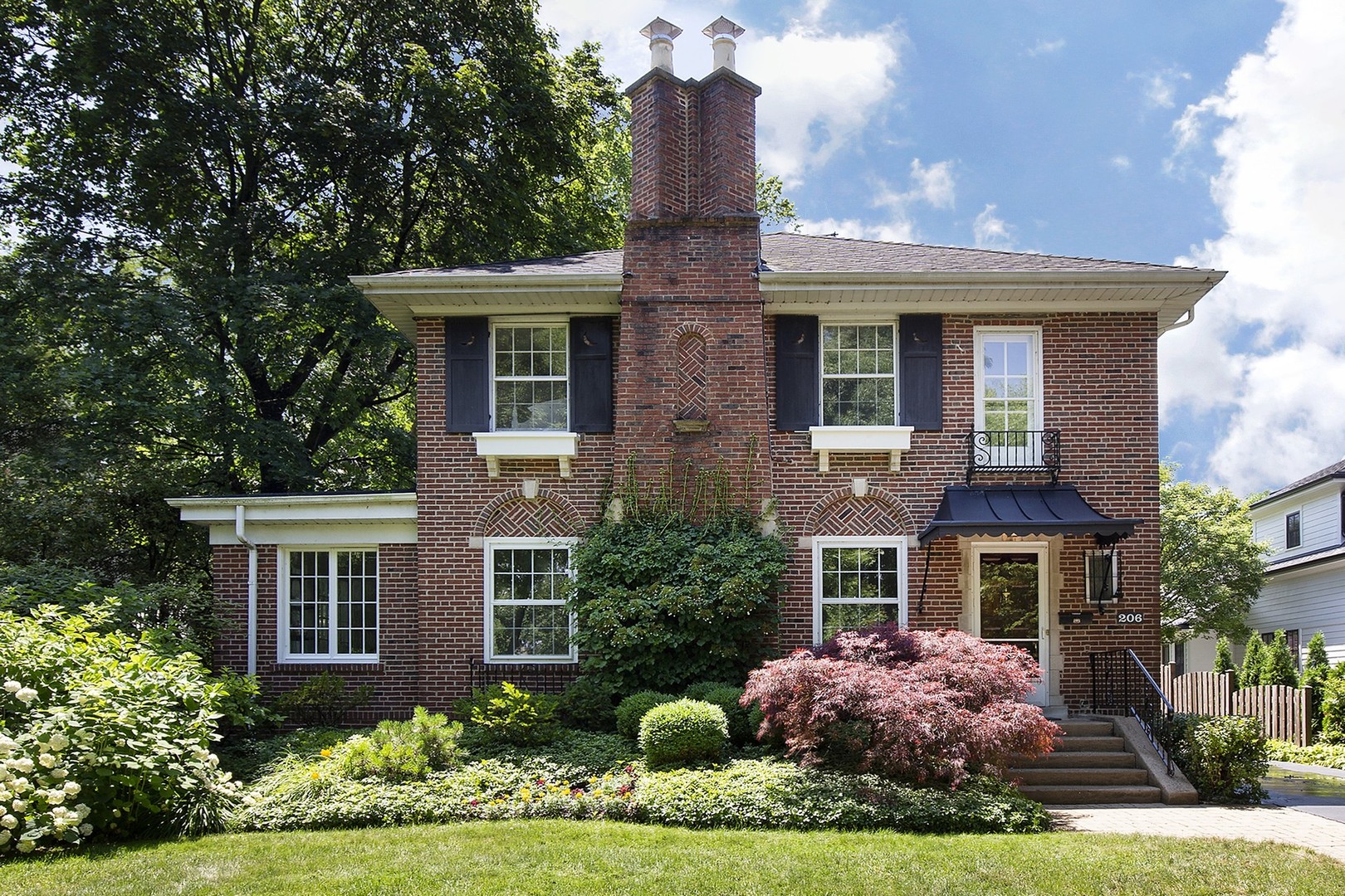 a front view of a house with yard and porch