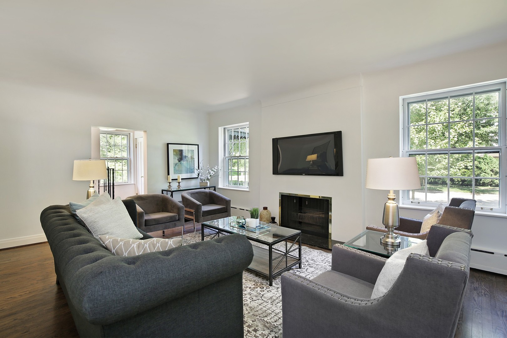 206 Sheridan Road Winnetka, IL 60093 - Photo 3 of 20 a living room with furniture a fireplace and a flat screen tv