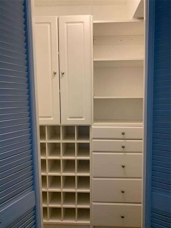 3121 Rosedale Avenue University Park, TX 75205 - Photo 14 of 16 Sample custom closet system featuring white cabinetry, adjustable shelving, multiple drawers with silver hardware, and integrated storage cubbies
