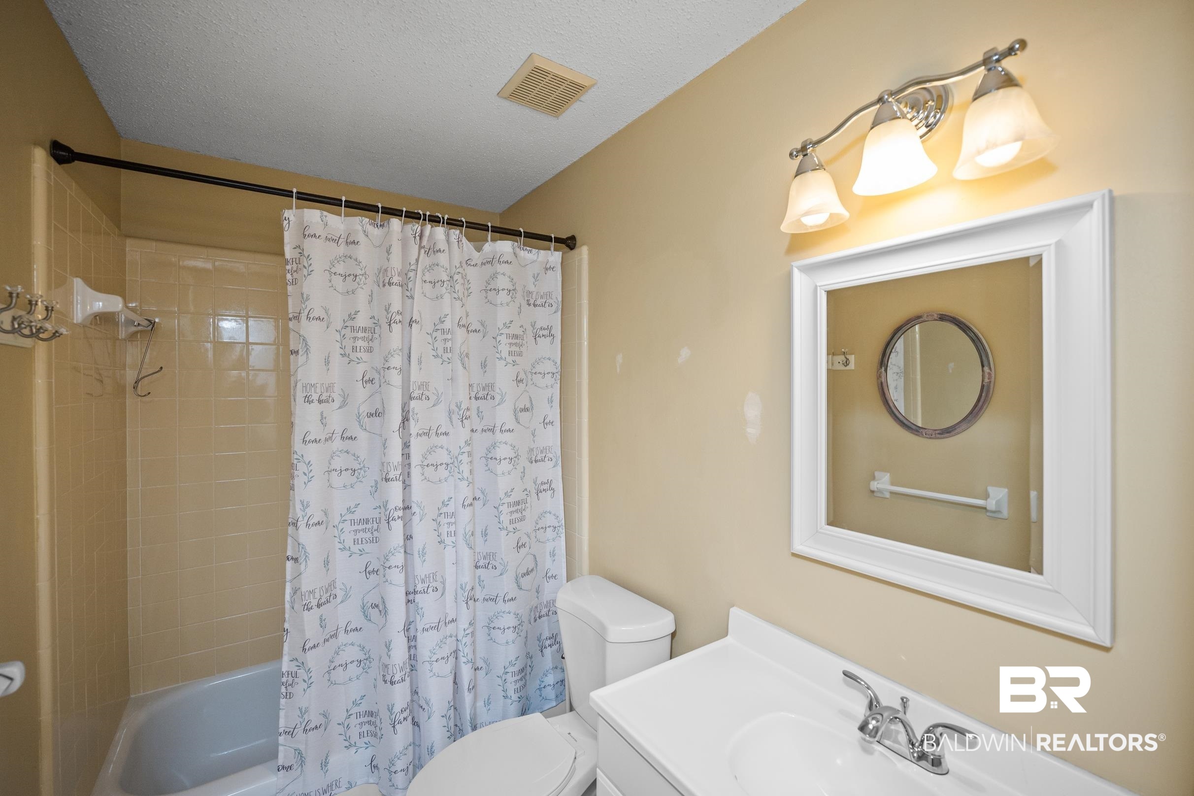 123 Dunbar Loop Daphne, AL 36526 - Photo 21 of 33 Full bathroom with shower / tub combo with curtain, vanity, and a textured ceiling
