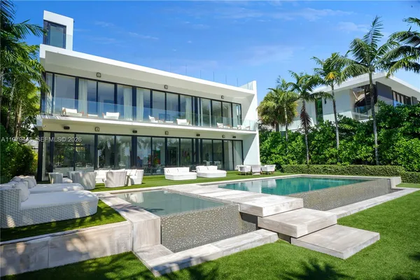 a house view with swimming pool and garden view