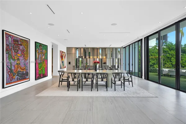 a large kitchen with kitchen island a large window in it