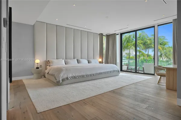 a bedroom with a large bed and a large window