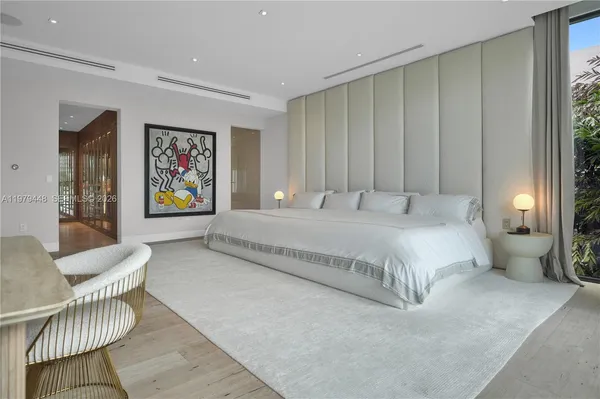 a bedroom with a large bed and a large window with outer view