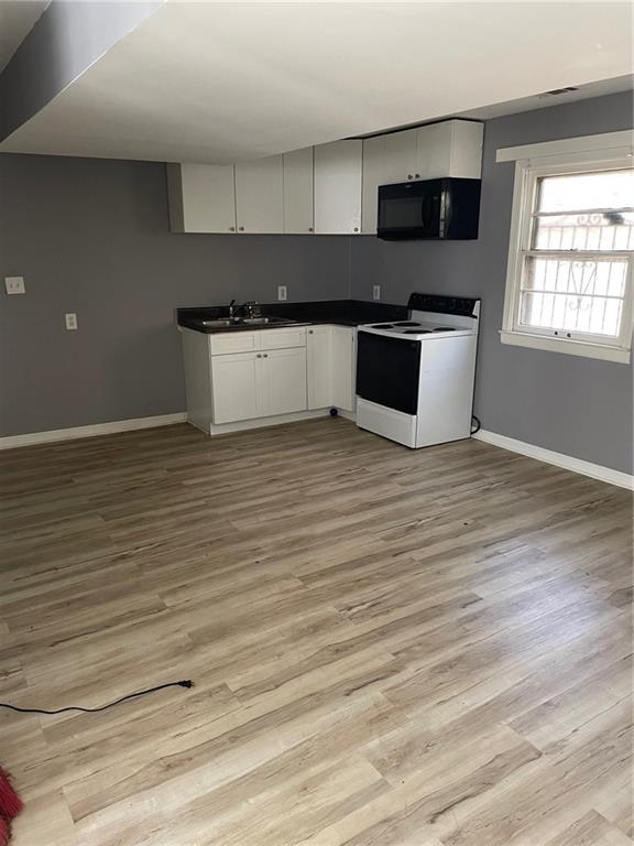 3587 Fairburn Place Northwest Atlanta, GA 30331 - Photo 12 of 12 a kitchen with stainless steel appliances wooden cabinets and a wooden floor