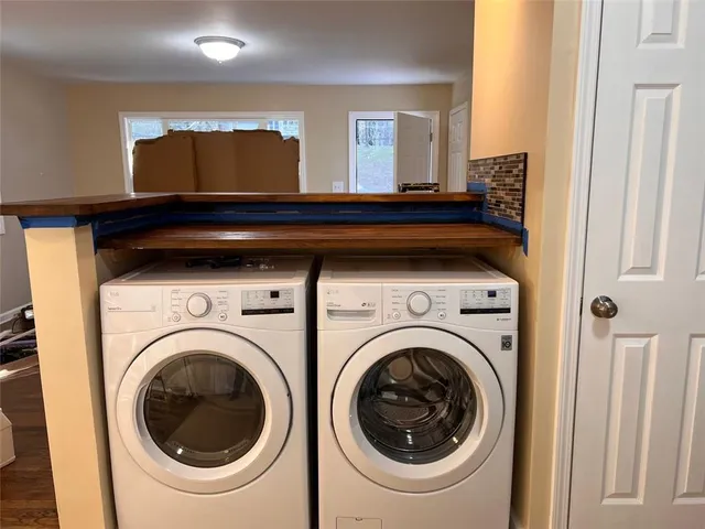 a view of a hallway with washer and dryer