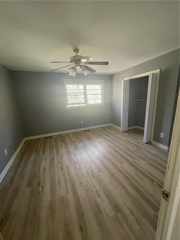 3587 Fairburn Place Northwest Atlanta, GA 30331 - Photo 9 of 12 wooden floor in an empty room with a window
