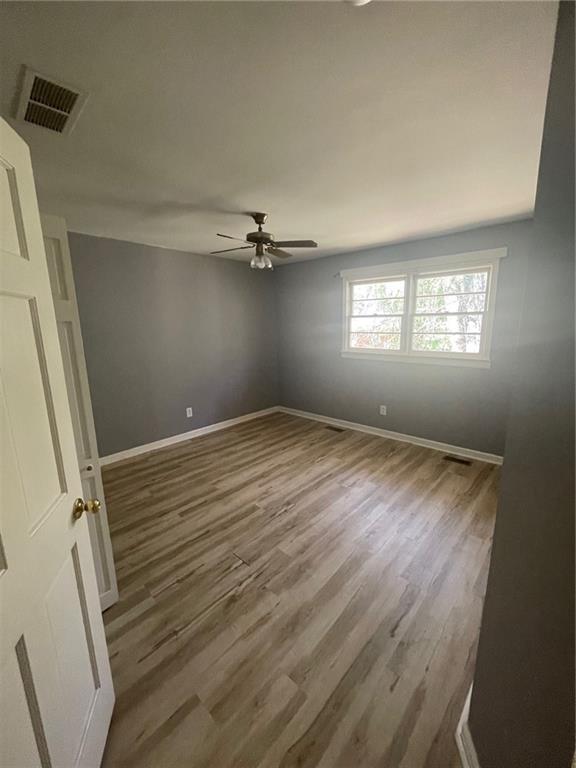 3587 Fairburn Place Northwest Atlanta, GA 30331 - Photo 10 of 12 wooden floor in an empty room with a window