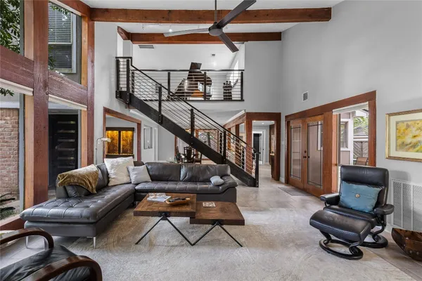 a living room with furniture and painting on the wall