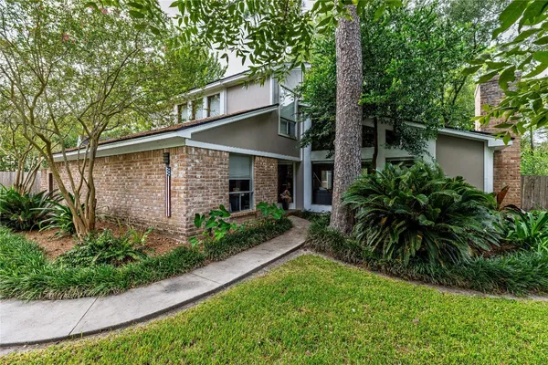 a living room with furniture a floor to ceiling window and a flat screen tv
