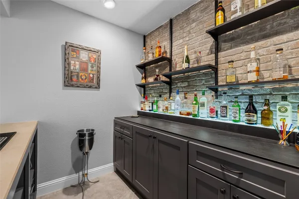 a view of backyard with seating space and wooden fence
