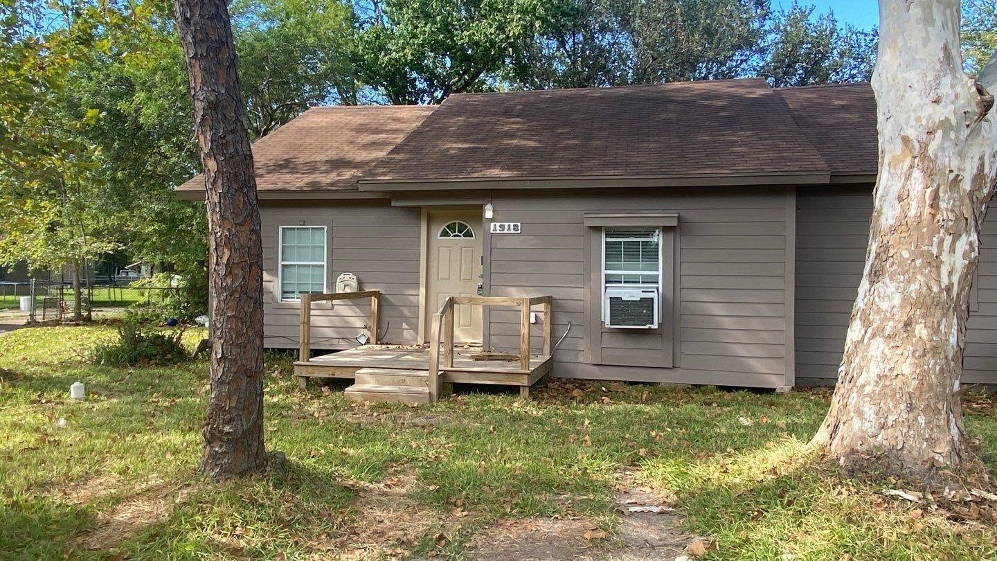 a view of a wooden house with a yard