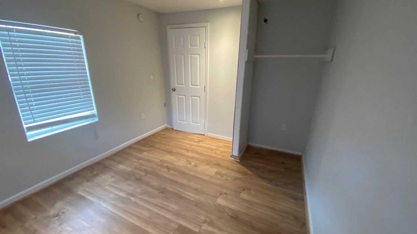 1918 Oleander La Marque, TX 77568 - Photo 12 of 20 an empty room with wooden floor and windows