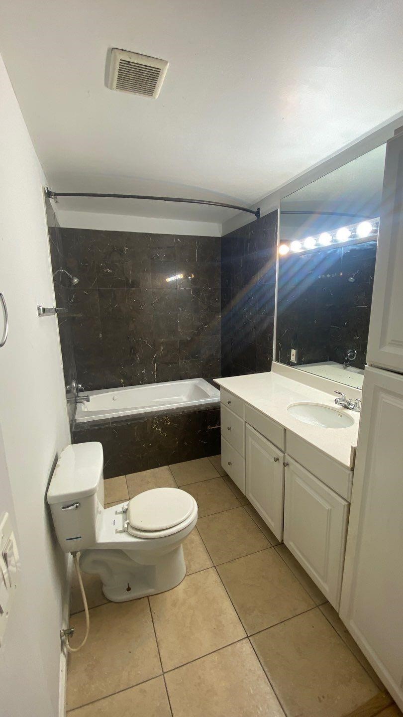 1918 Oleander La Marque, TX 77568 - Photo 14 of 20 a bathroom with a toilet a sink and mirror