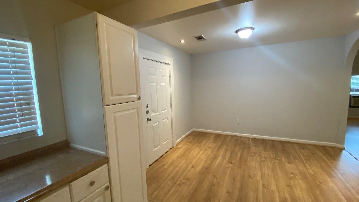 1918 Oleander La Marque, TX 77568 - Photo 5 of 20 a view of a room with wooden floor and cabinet