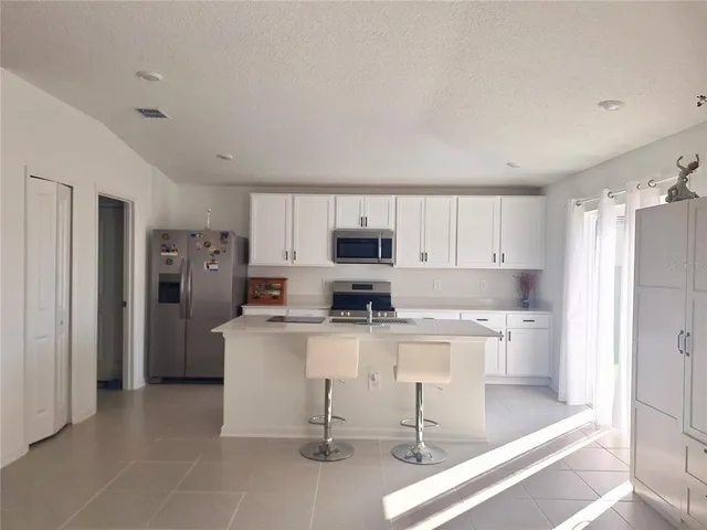 a kitchen with stainless steel appliances a refrigerator and a stove top oven