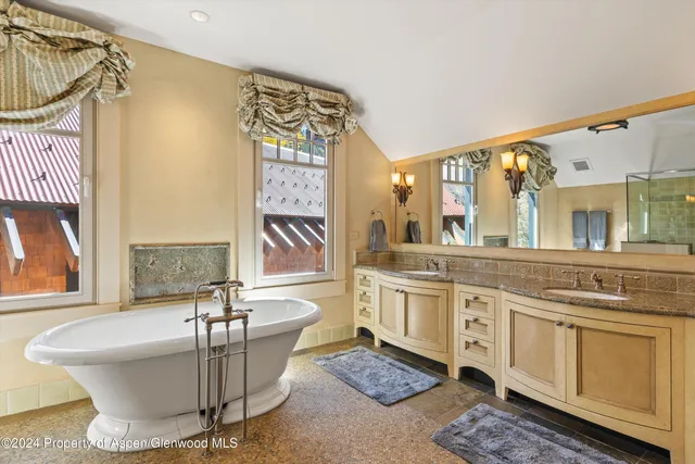 a living room with a couch and dresser with wooden floor