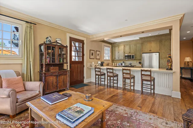 a living room with furniture a flat screen tv and a table