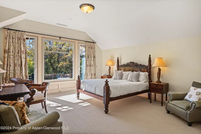 a bed room with furniture and a large window