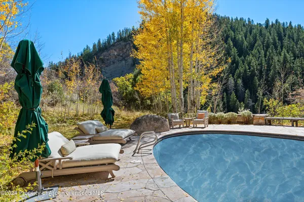 a view of a swimming pool with a patio