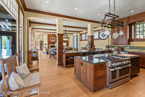 a kitchen with a stove and a view of living room