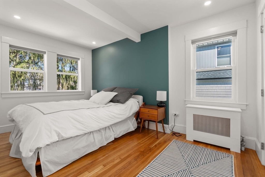 69 Henderson Street Needham, MA 02492 - Photo 13 of 26 a bedroom with a bed and a fireplace